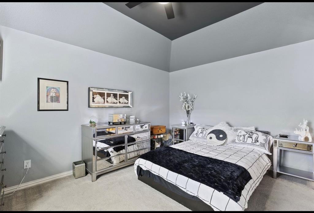 2257 Hermitage Drive Allen, TX 75013 - Photo 35 of 40 a bedroom with a bed and a tv on the wall