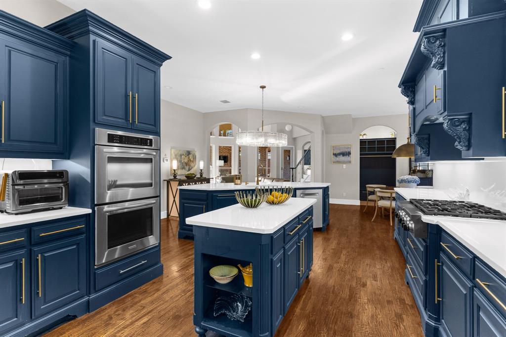 2257 Hermitage Drive Allen, TX 75013 - Photo 5 of 40 a kitchen with kitchen island granite countertop a stove oven and a refrigerator