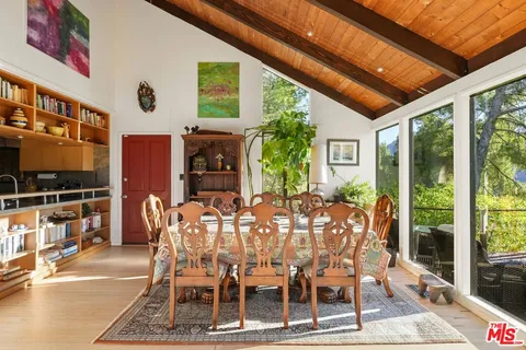 a kitchen with a table chairs stove and cabinets