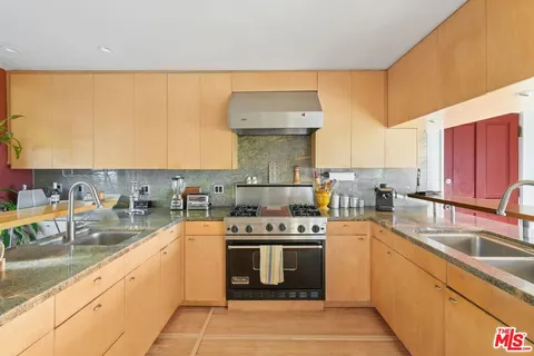 a bed room with two bed and a book shelf
