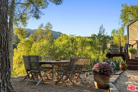 a view of a two chairs in the patio