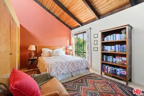 a bed room with a bed and a large window