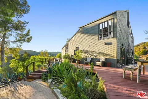 a view of an outdoor sitting area with brick wall