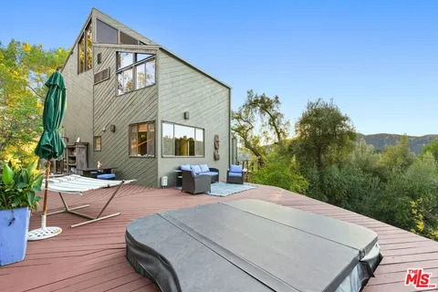a view of a yard with plants and trees