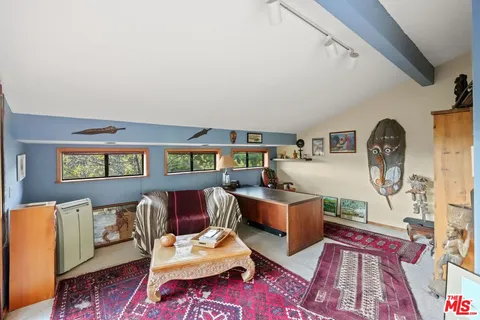 a view of a houses with a lush green hillside