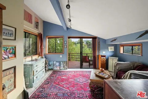 a view of a mountain in the distance in a field