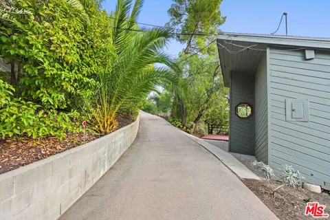 a backyard of a house with table and chairs