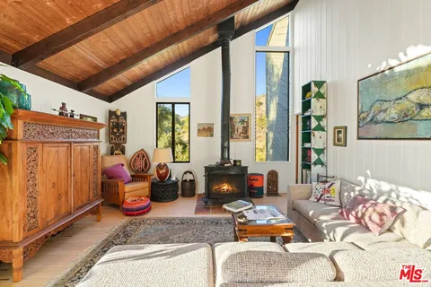a patio with table and chairs and potted plants