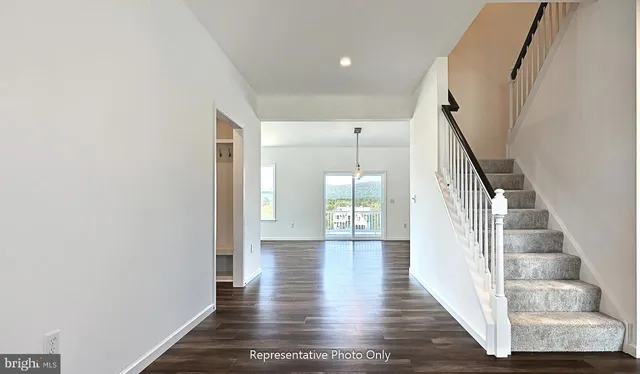a view of an entryway with wooden floor