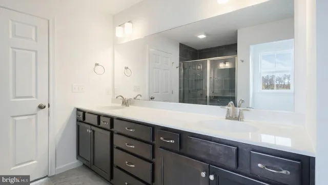 a bathroom with a sink double vanity and a mirror