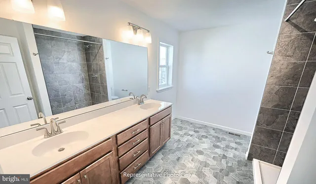 a bathroom with a double vanity sink and a mirror