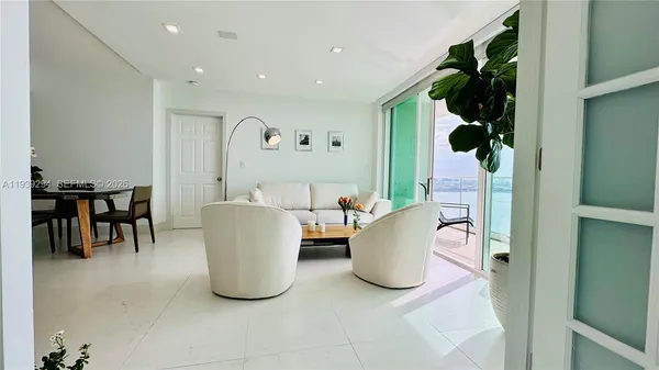 a bedroom with a bed and a flat tv screen on the dresser