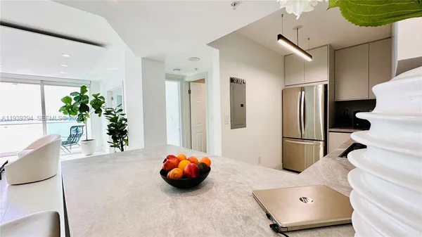 a living room with furniture and a potted plant