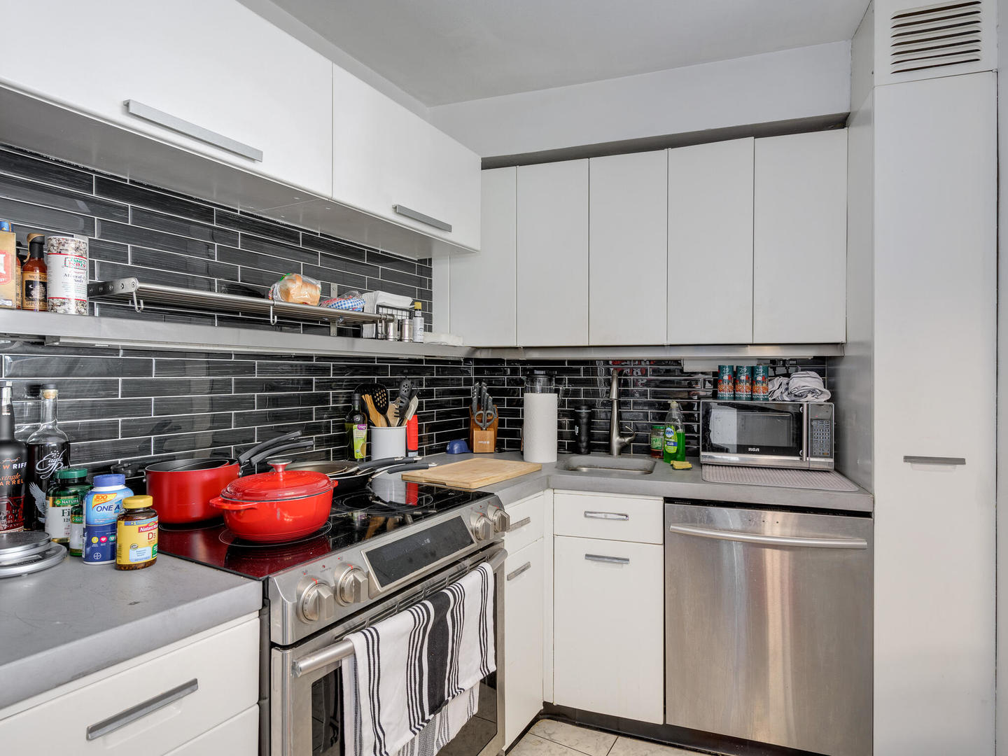 300 North State Street, Unit 4802 Chicago, IL 60654 - Photo 4 of 15 a kitchen with stainless steel appliances granite countertop a sink stove and cabinets