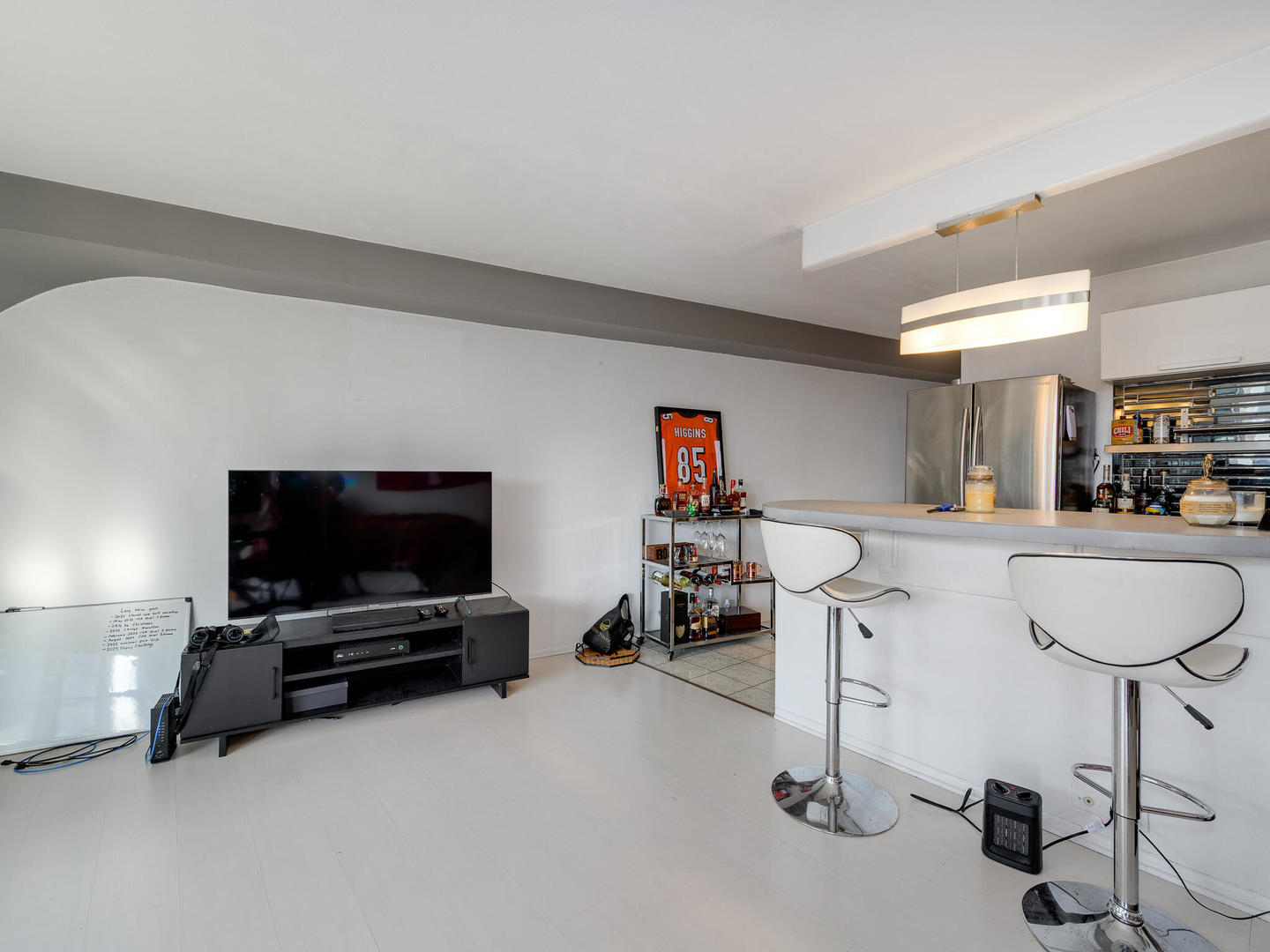 300 North State Street, Unit 4802 Chicago, IL 60654 - Photo 6 of 15 a living room with furniture and a flat screen tv