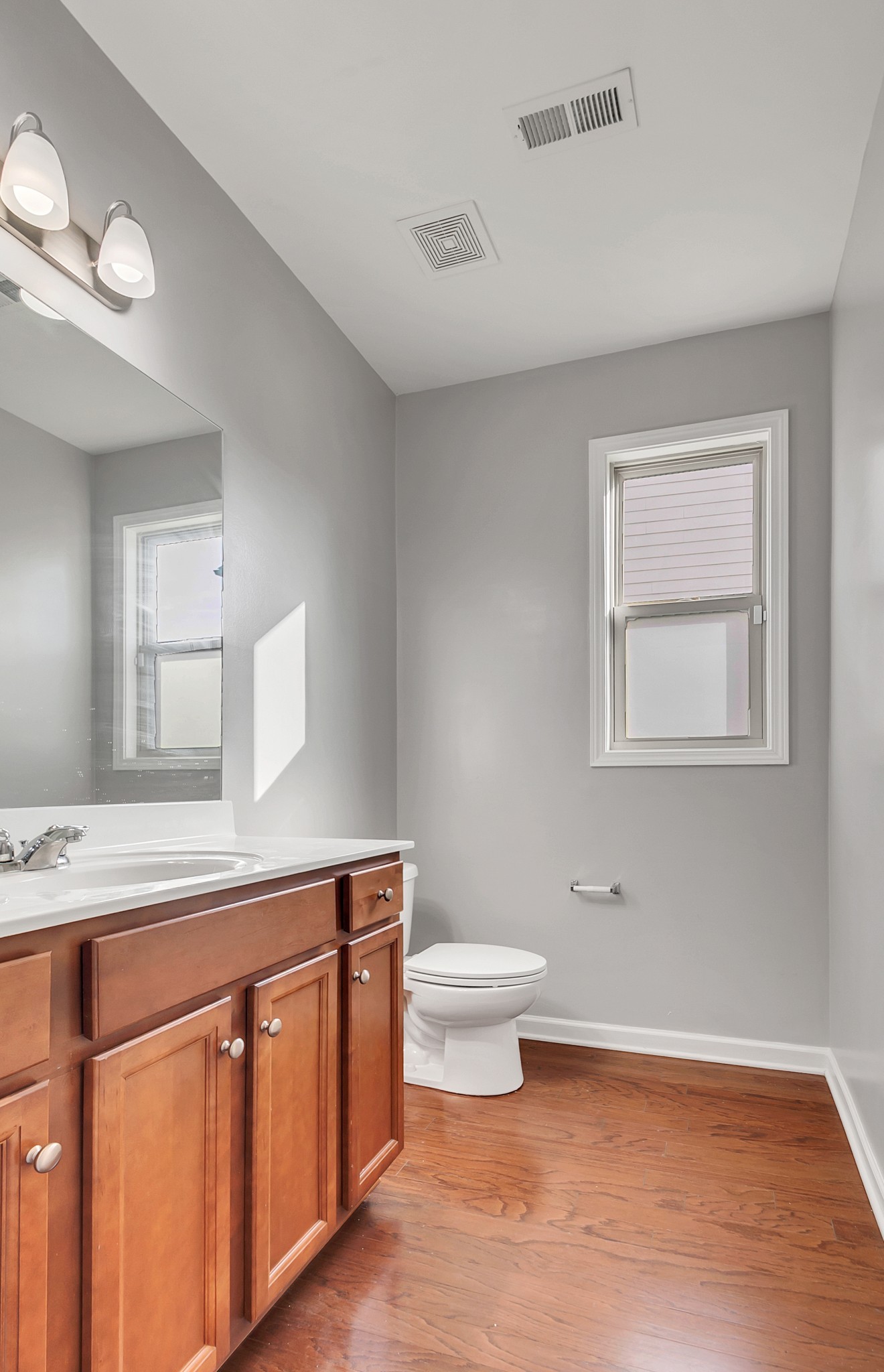 3005 Alan Drive Spring Hill, TN 37174 - Photo 11 of 41 a bathroom with a toilet a sink a mirror and a window