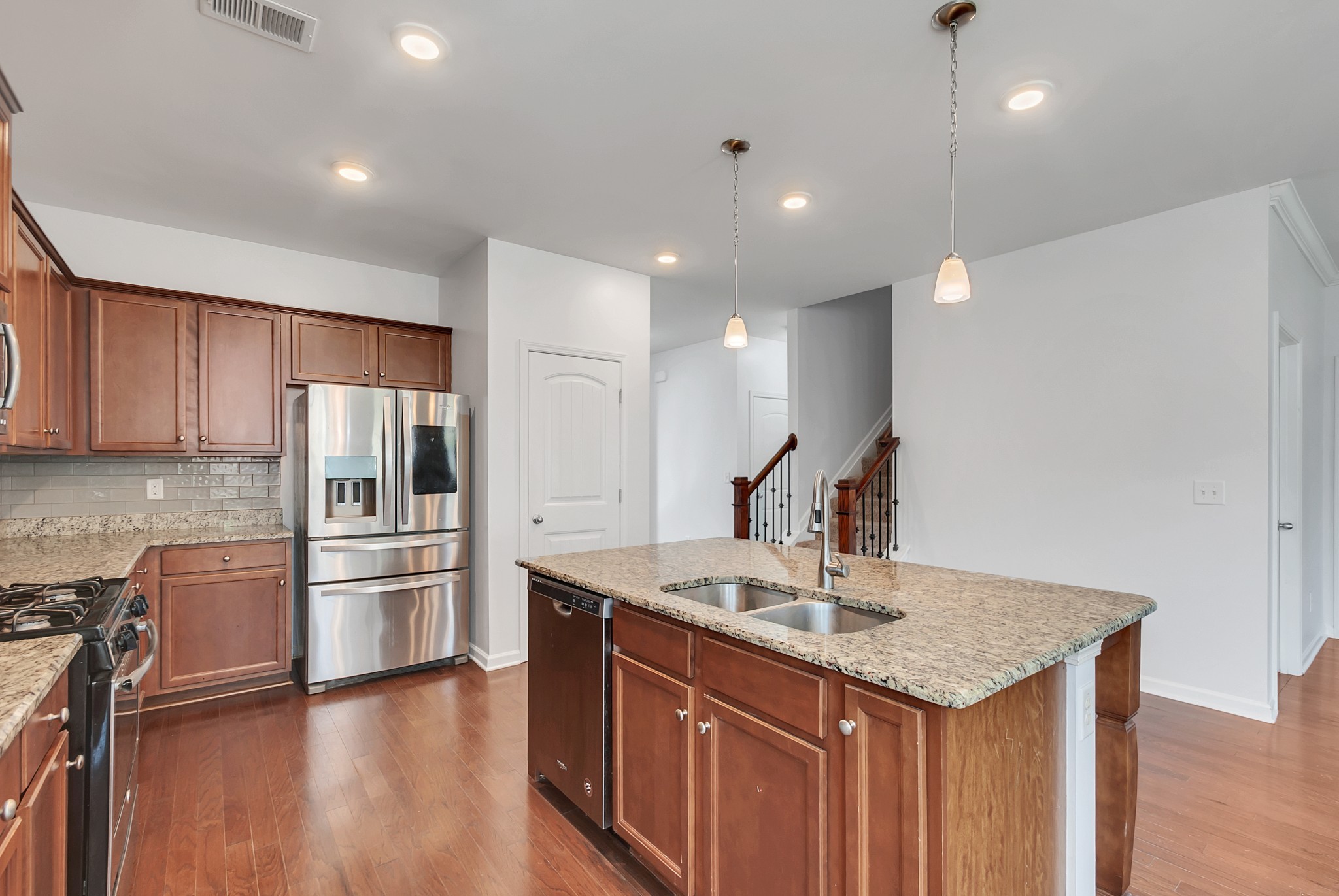 3005 Alan Drive Spring Hill, TN 37174 - Photo 14 of 41 a kitchen with stainless steel appliances granite countertop a sink a stove and a refrigerator