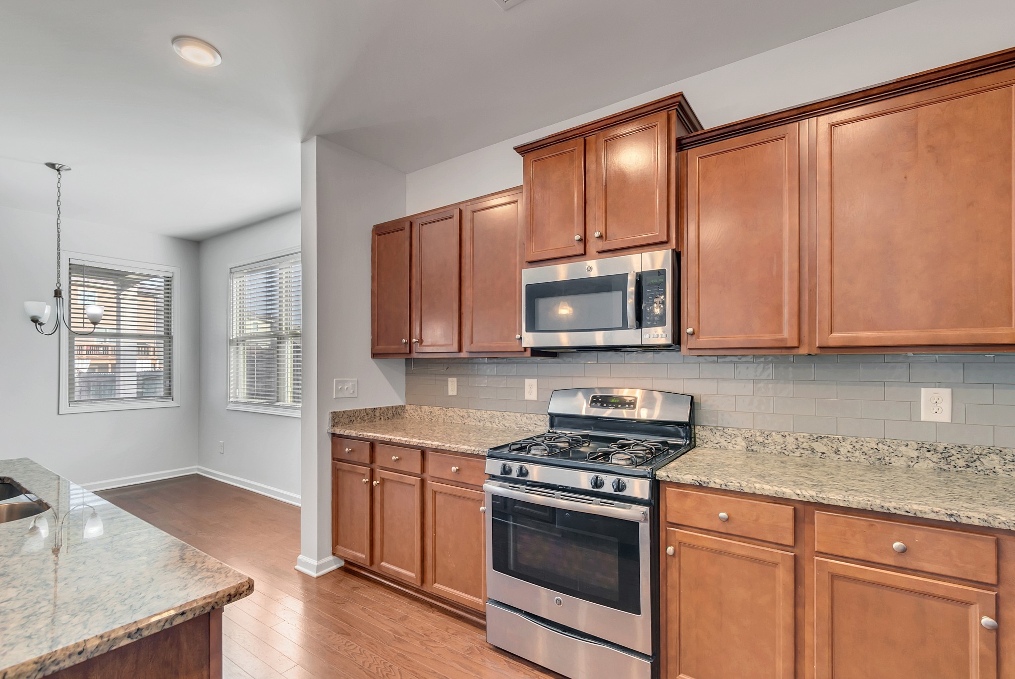 3005 Alan Drive Spring Hill, TN 37174 - Photo 15 of 41 a kitchen with stainless steel appliances granite countertop a stove a sink and a microwave