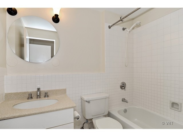 40 East 9th Street, Unit 804 Chicago, IL 60605 - Photo 7 of 16 a bathroom with a sink a toilet and shower