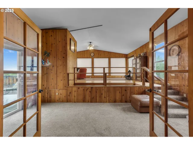 a living room with furniture and a kitchen