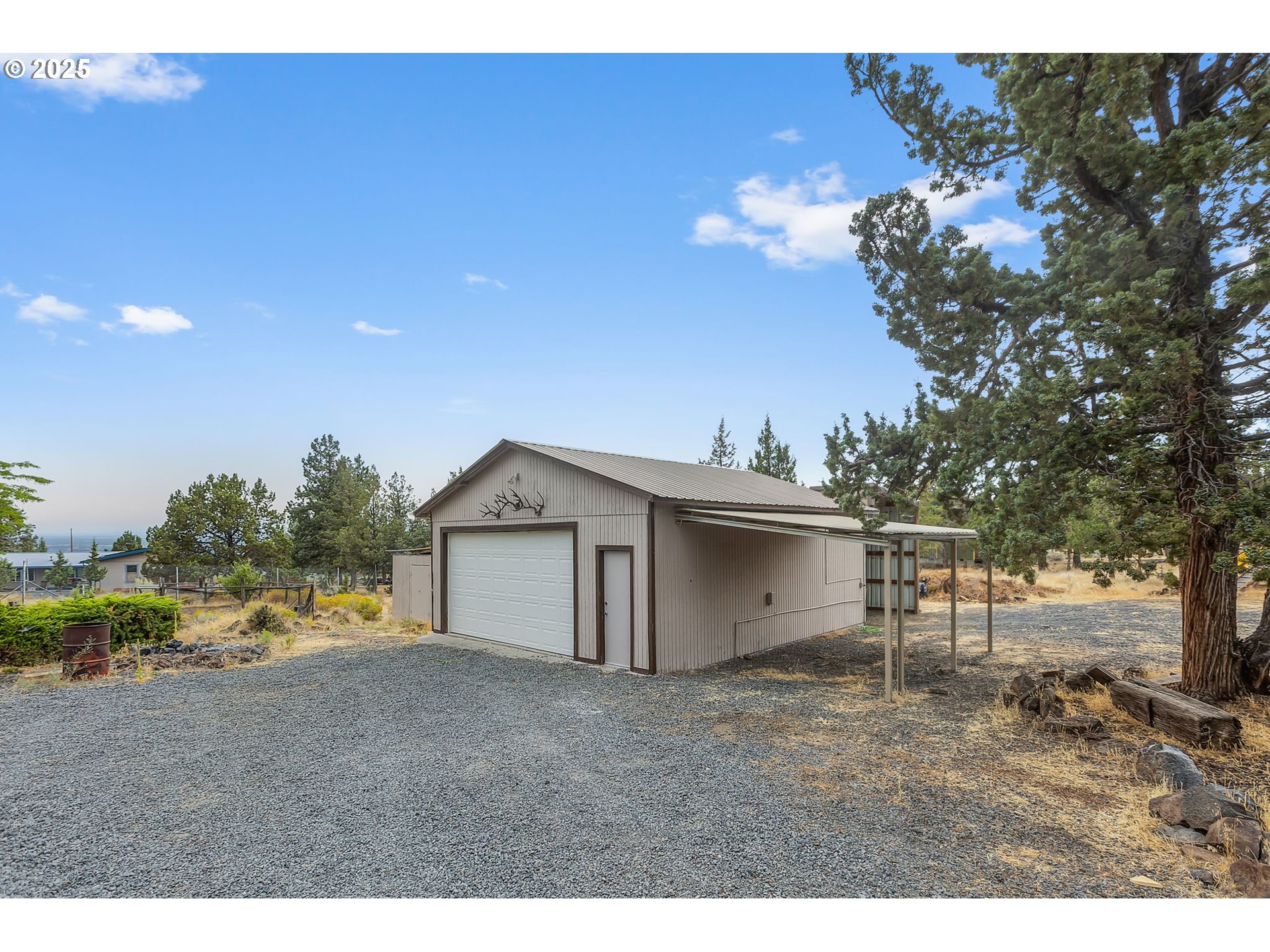 5969 Southwest Sundance Lane Culver, OR 97734 - Photo 20 of 23 a view of a house with a yard and garage