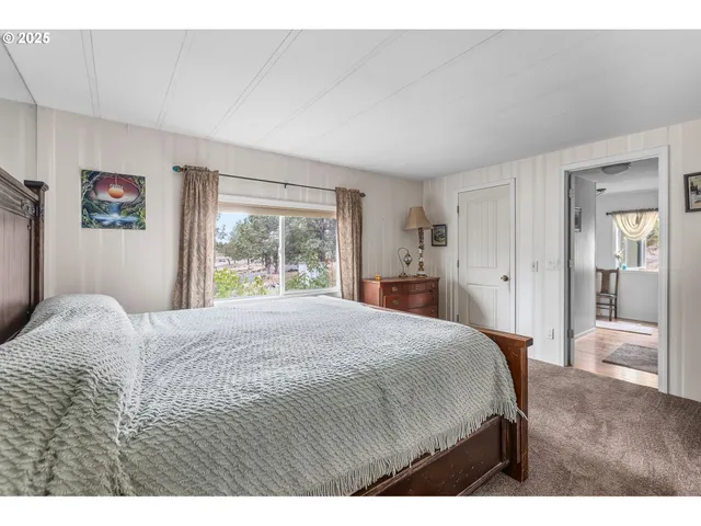 a bedroom with a large bed and a window