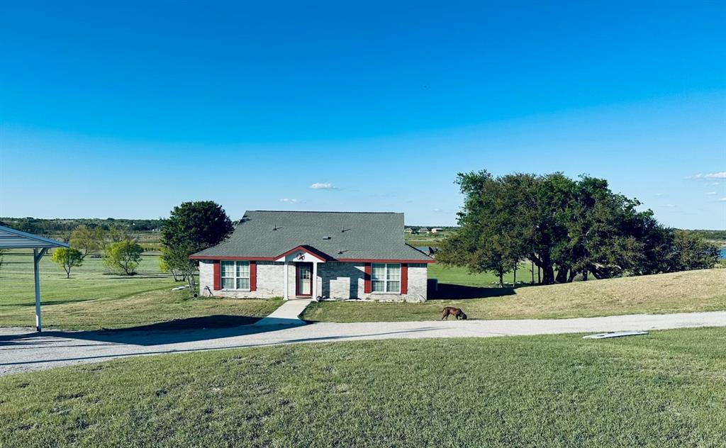 333 Lake Point Road Comanche, TX 76442 - Photo 1 of 4 a front view of a house with a yard
