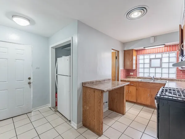 a kitchen with a stove a sink and a refrigerator