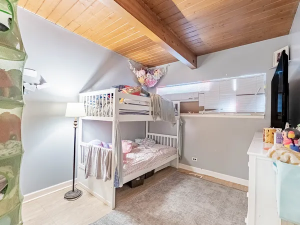 a bedroom with a bed and a dresser