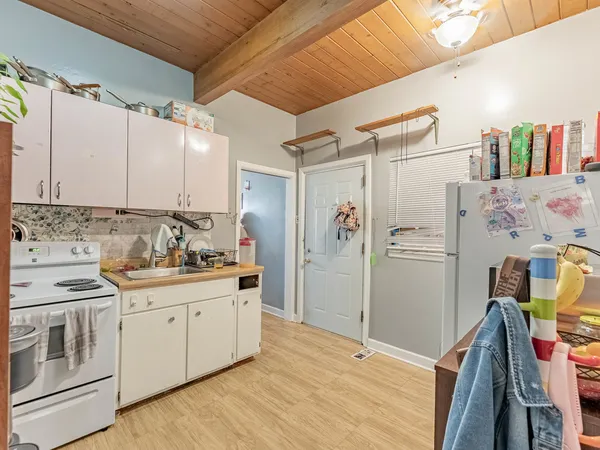 a kitchen with stainless steel appliances a stove a sink and a refrigerator