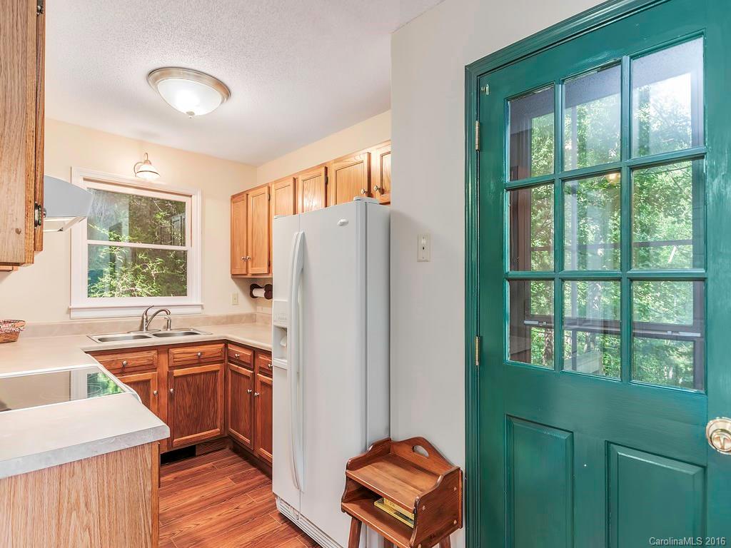 322 Old Country Road Waynesville, NC 28786 - Photo 6 of 12 a kitchen with a sink a counter top space and stainless steel appliances
