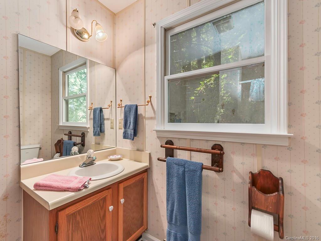 322 Old Country Road Waynesville, NC 28786 - Photo 8 of 12 a bathroom with a sink a vanity and a mirror