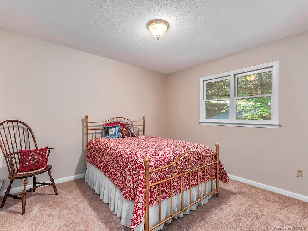 322 Old Country Road Waynesville, NC 28786 - Photo 9 of 12 a bedroom with a bed and a window