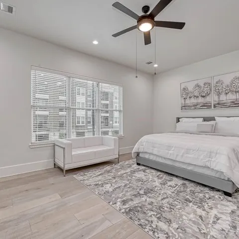 a spacious bedroom with a large bed and a window