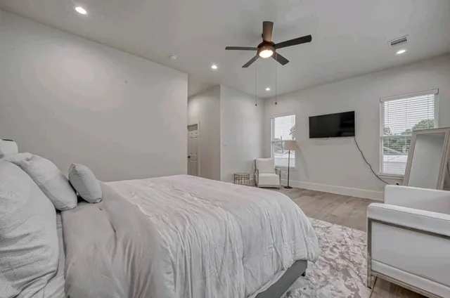 a bedroom with a large bed and a window