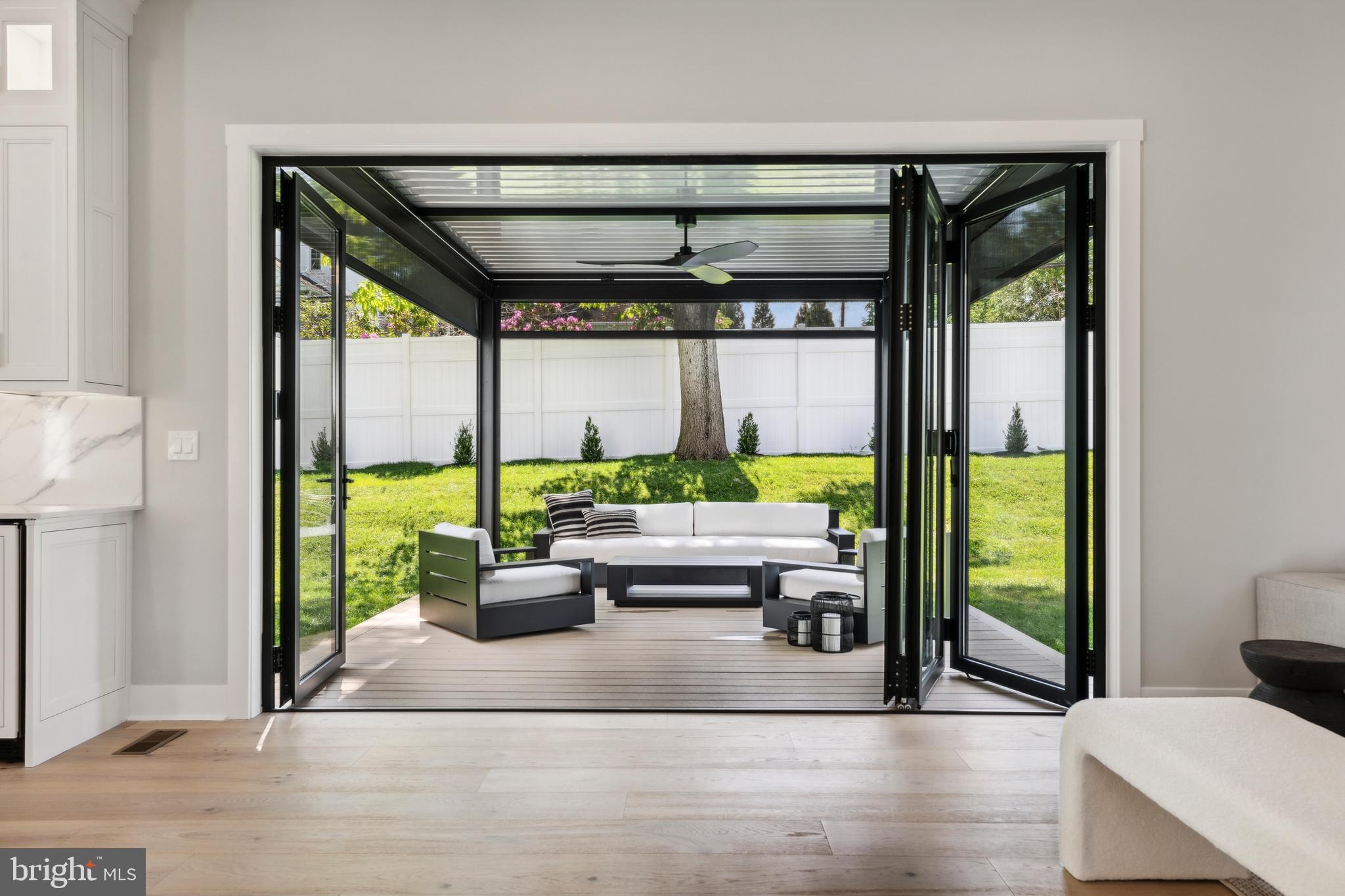761 Mt Moro Road Villanova, PA 19085 - Photo 38 of 92 a living room with large windows and a table