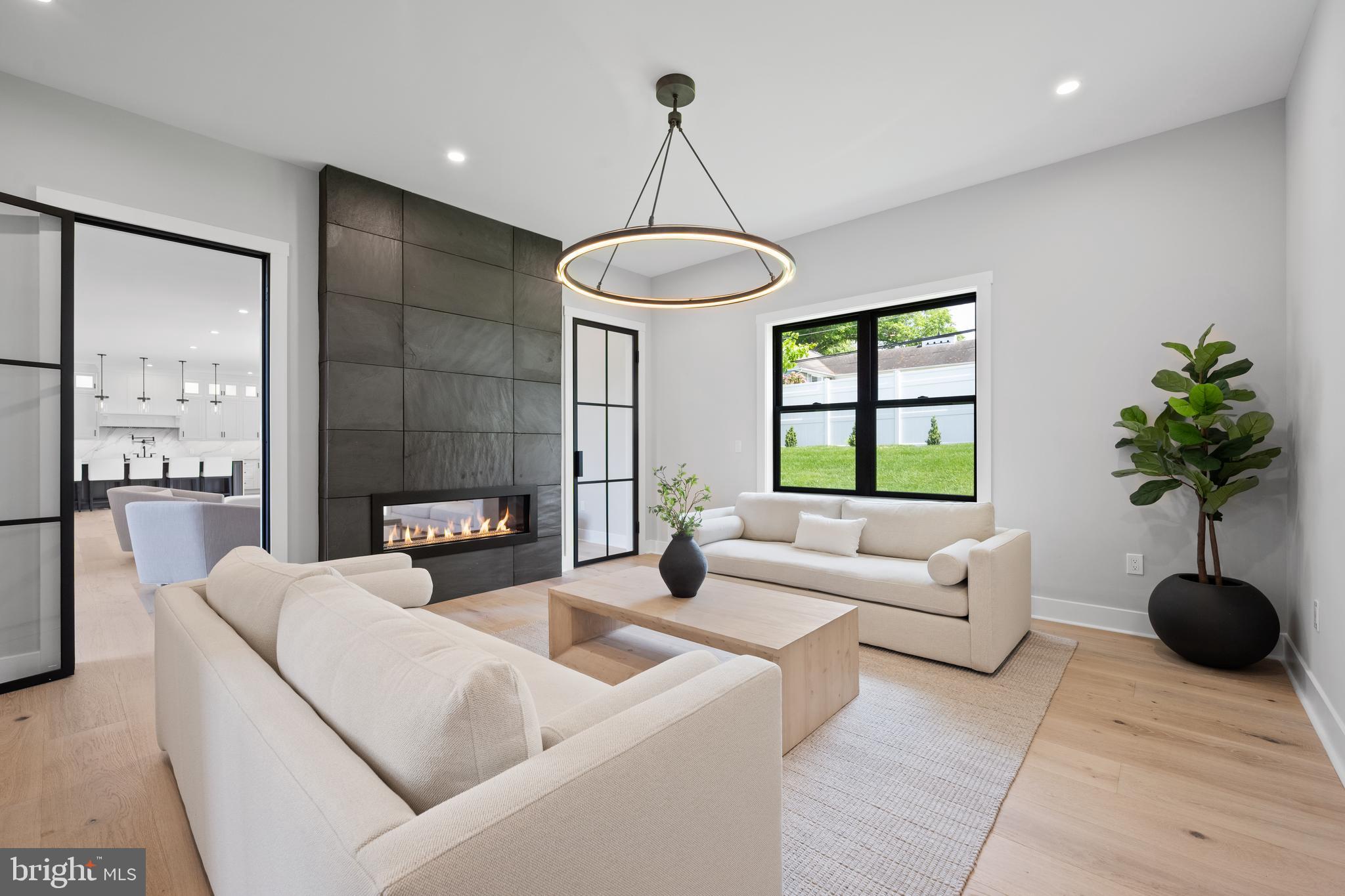 761 Mt Moro Road Villanova, PA 19085 - Photo 46 of 92 a living room with furniture a chandelier and a large window