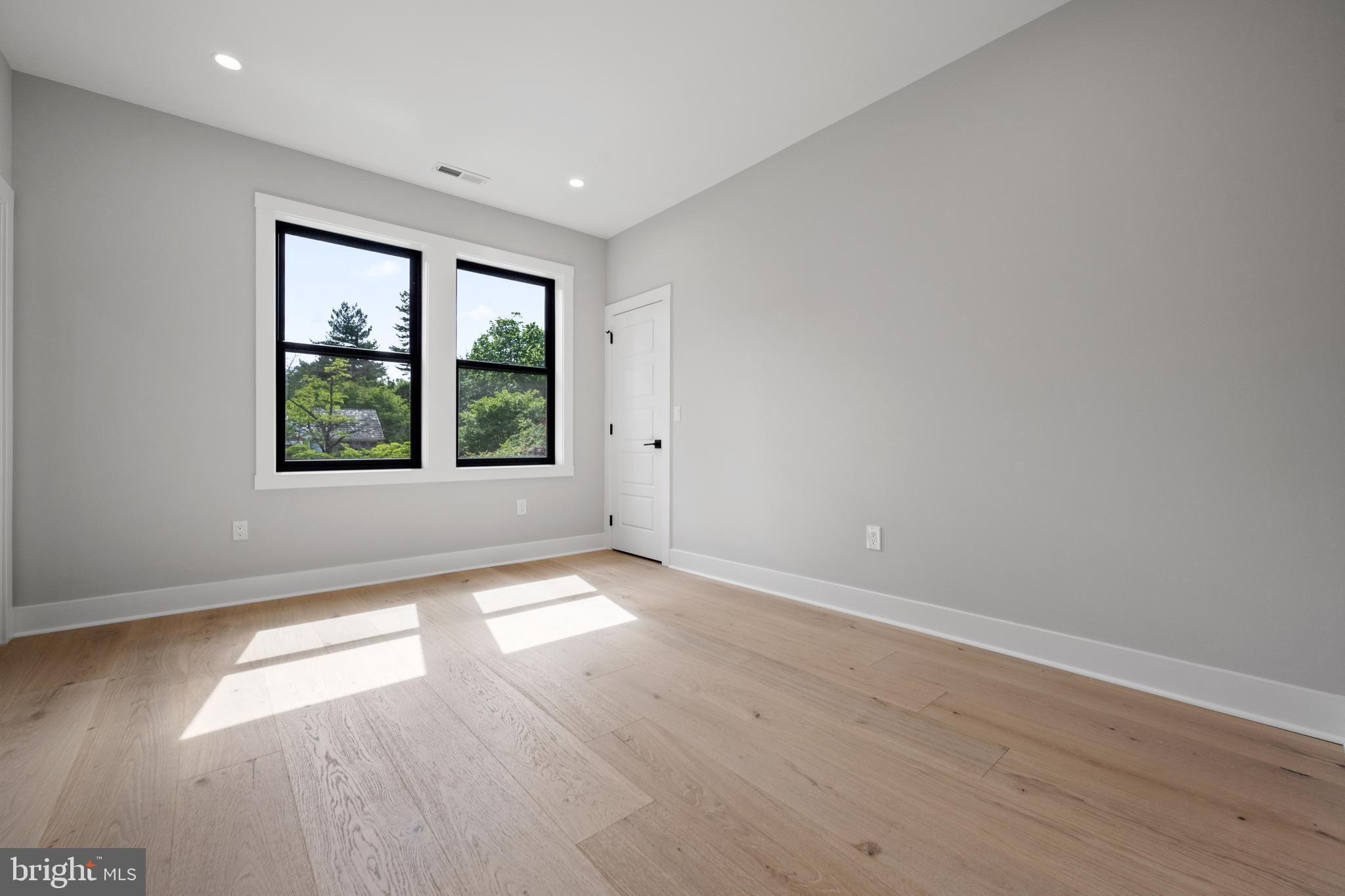 761 Mt Moro Road Villanova, PA 19085 - Photo 81 of 92 an empty room with wooden floor and windows