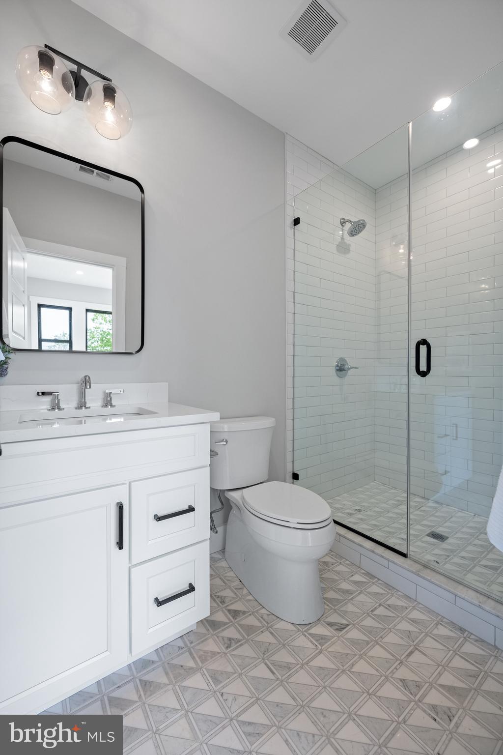 761 Mt Moro Road Villanova, PA 19085 - Photo 85 of 92 a bathroom with a toilet a sink a glass door a shower a mirror and vanity