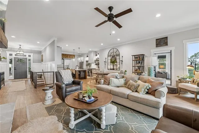a kitchen with stainless steel appliances a stove a sink a kitchen island and chairs