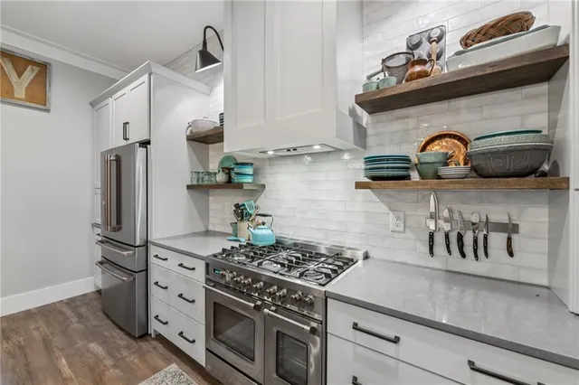 a bathroom with a granite countertop sink a toilet and a mirror