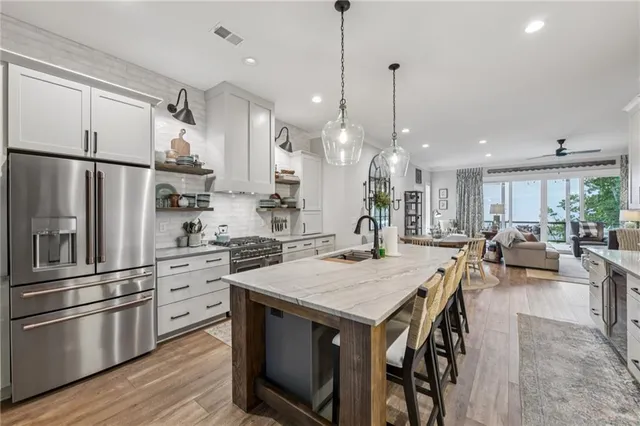 a room with gym equipment and wooden floor