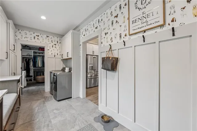 a bathroom with a granite countertop toilet sink and mirror