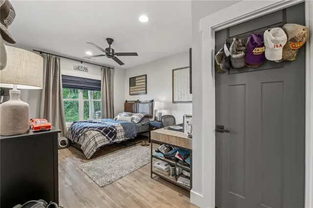 a view of a patio with table and chairs under an umbrella with large trees