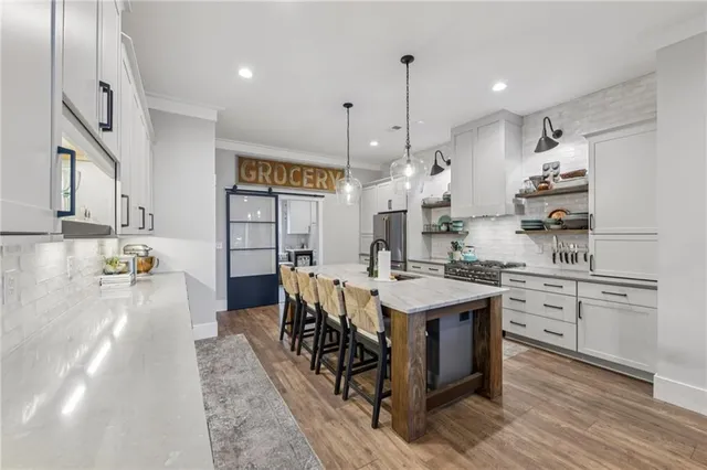 a living room with lots of furniture and a wooden floor