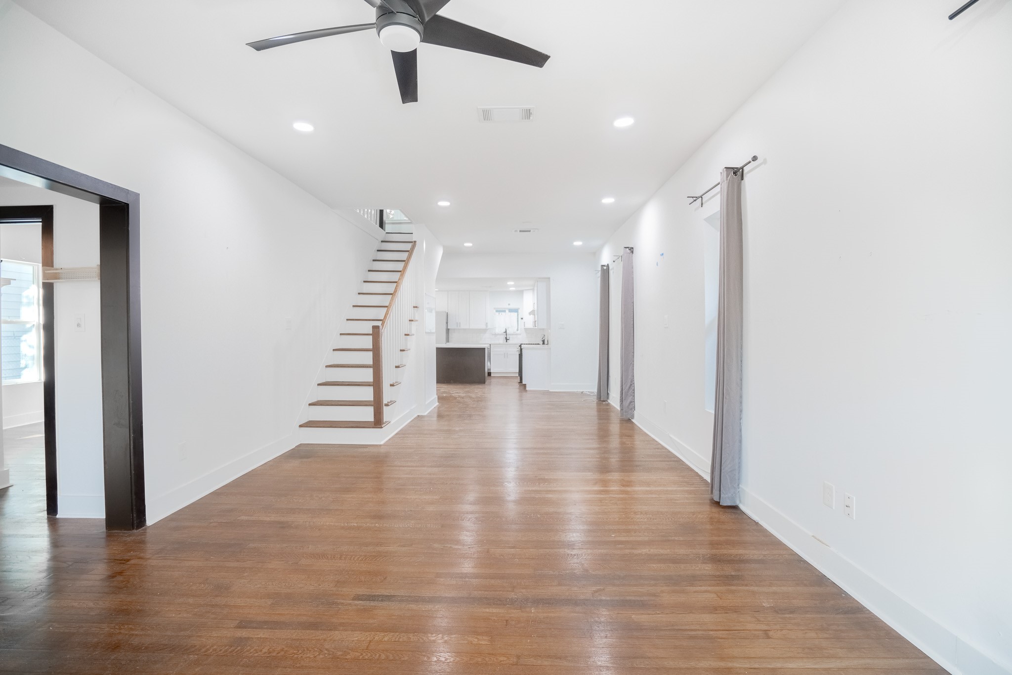 7305 Capitol Street Houston, TX 77011 - Photo 2 of 16 a view of an entryway with wooden floor and a ceiling fan