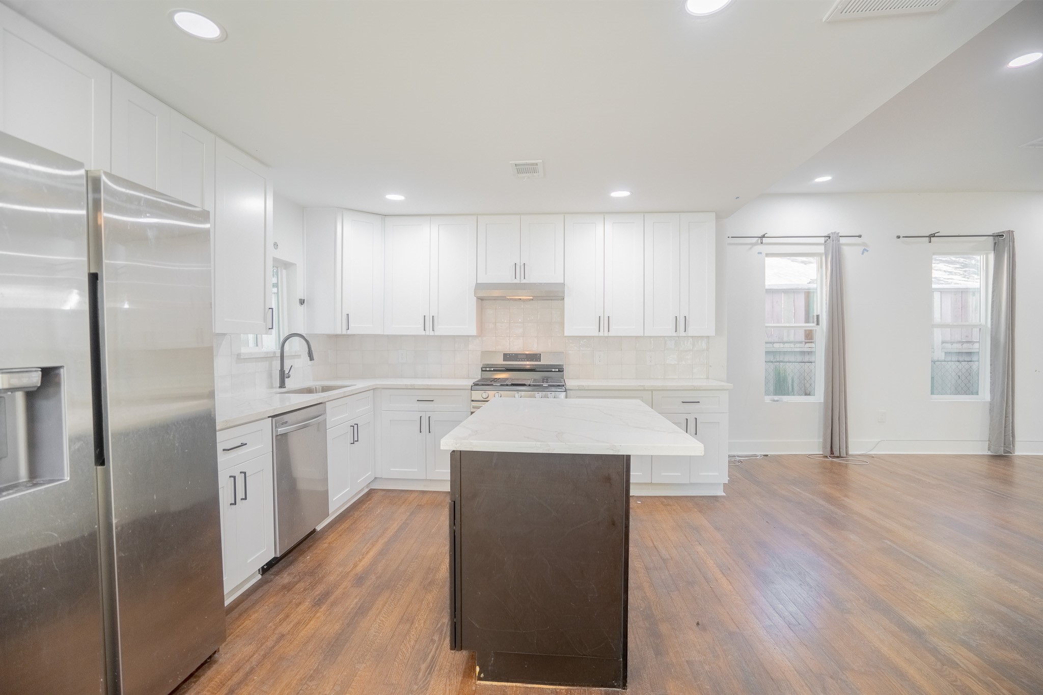 7305 Capitol Street Houston, TX 77011 - Photo 7 of 16 a large kitchen with stainless steel appliances lots of counter top space and a refrigerator