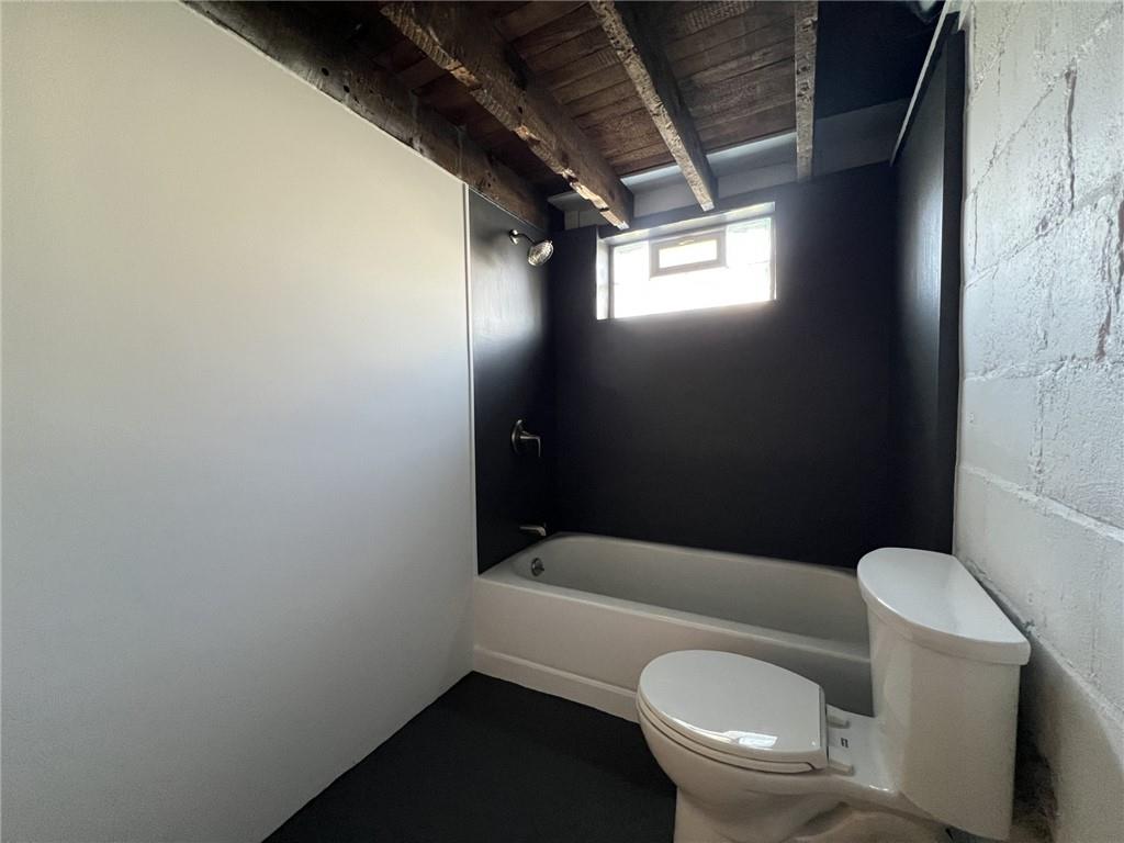 37 Lebanon Avenue Uniontown, PA 15401 - Photo 12 of 15 a white toilet sitting next to a bathroom sink and tub