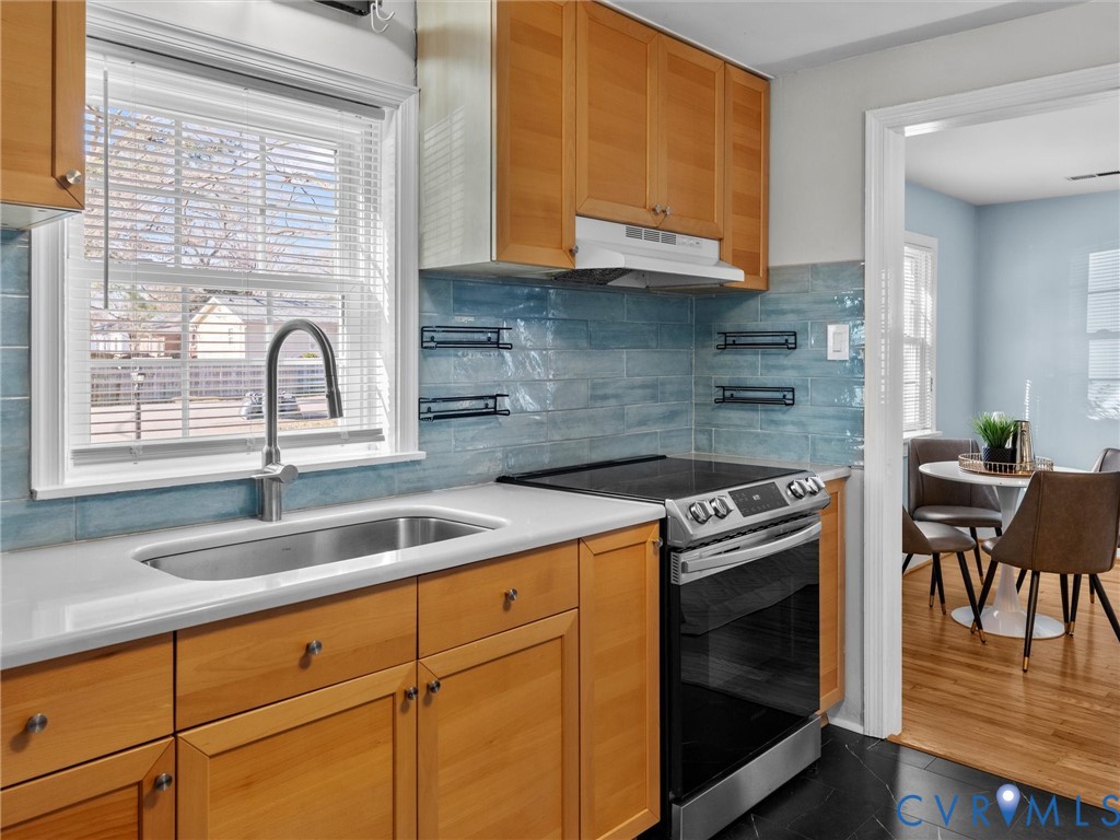6715 Galaxie Road Henrico, VA 23228 - Photo 13 of 40 a kitchen with granite countertop a stove a sink and cabinets