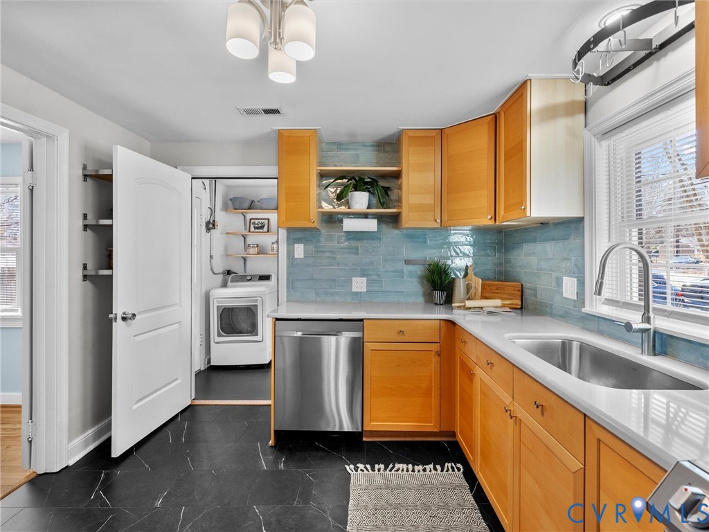 6715 Galaxie Road Henrico, VA 23228 - Photo 16 of 40 a kitchen with stainless steel appliances a sink cabinets and wooden floor
